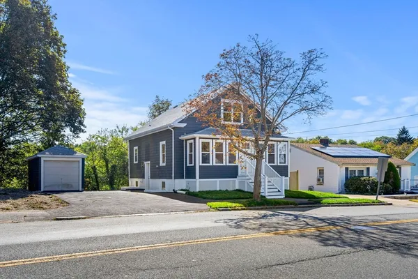 a front view of a house with a yard and garage