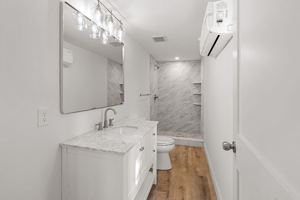 29 Willson Street Salem, MA 01970 - Photo 34 of 41 a bathroom with a granite countertop sink a mirror and shower