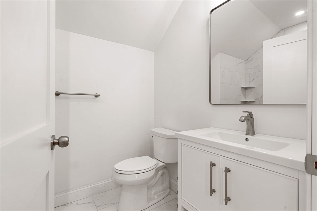 29 Willson Street Salem, MA 01970 - Photo 36 of 41 a bathroom with a sink a toilet and a mirror
