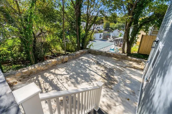 a view of a yard with plants and trees