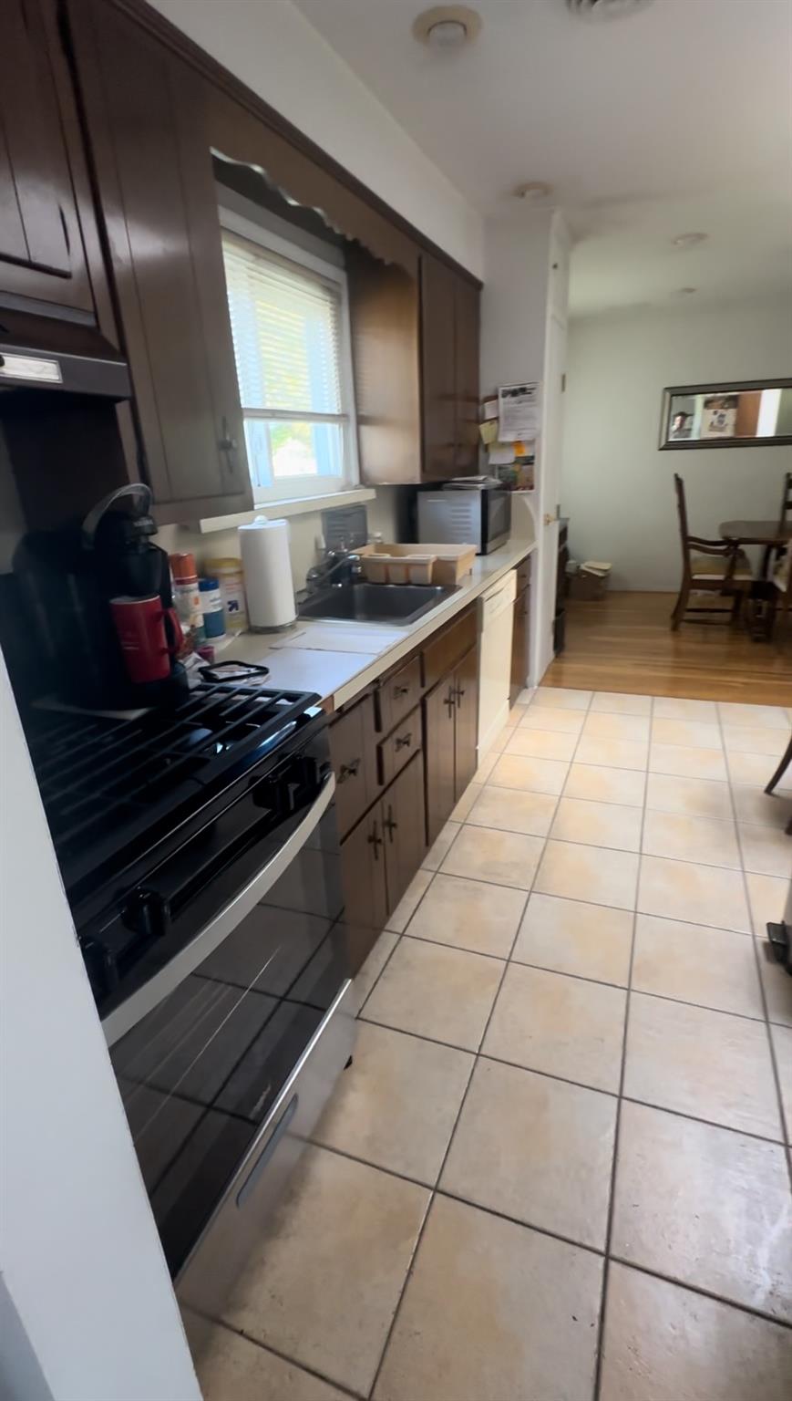 1 Scott Place Plainview, NY 11803 - Photo 3 of 5 a kitchen with stainless steel appliances granite countertop a stove a sink and a microwave