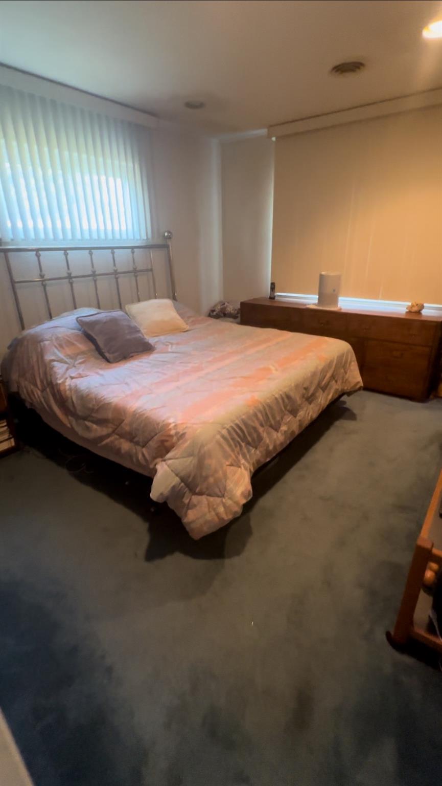 1 Scott Place Plainview, NY 11803 - Photo 5 of 5 a bedroom with a bed and a couch