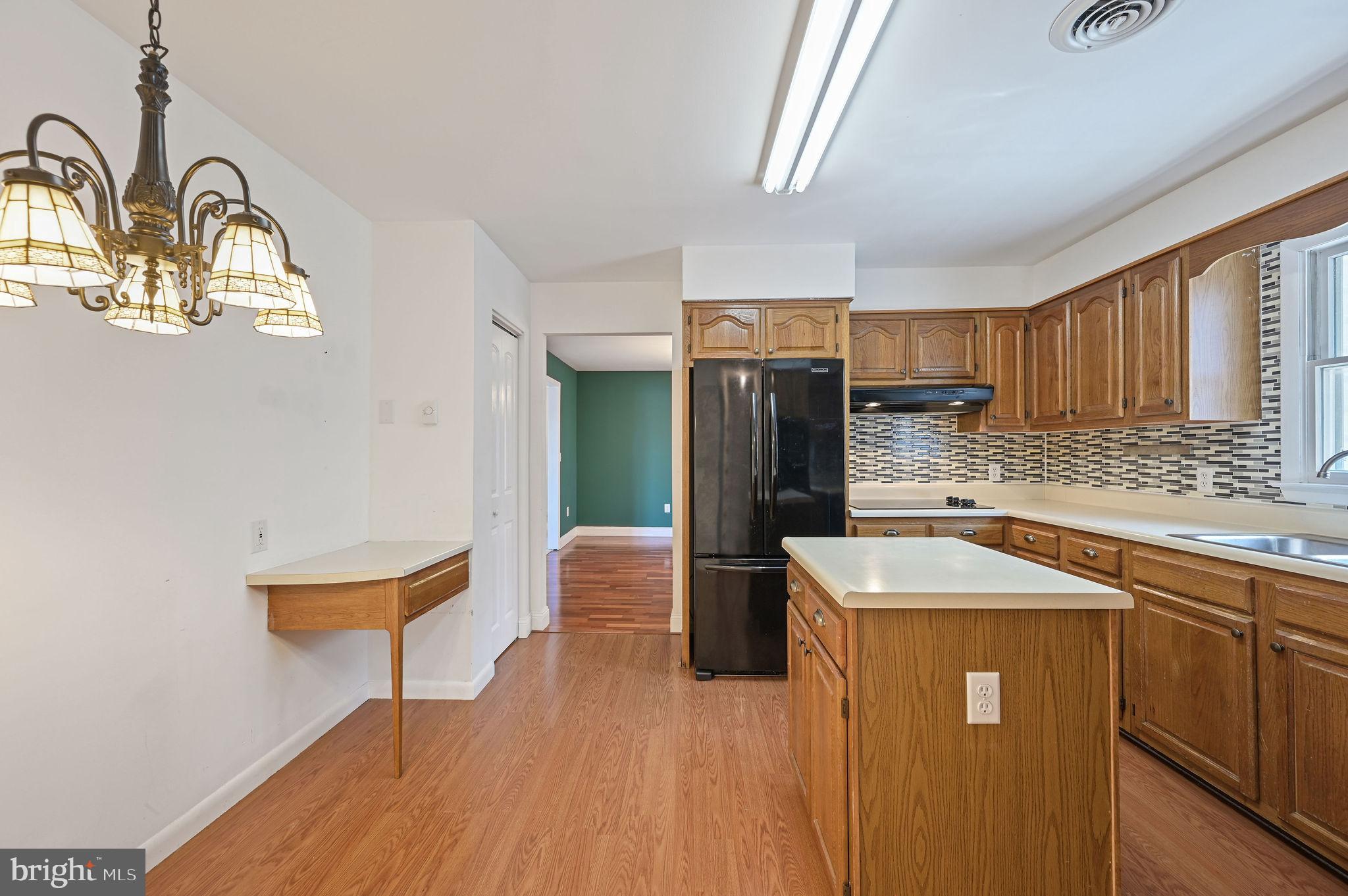 231 East Evens Road Viola, DE 19979 - Photo 16 of 36 a kitchen with stainless steel appliances granite countertop a refrigerator a sink a stove and island