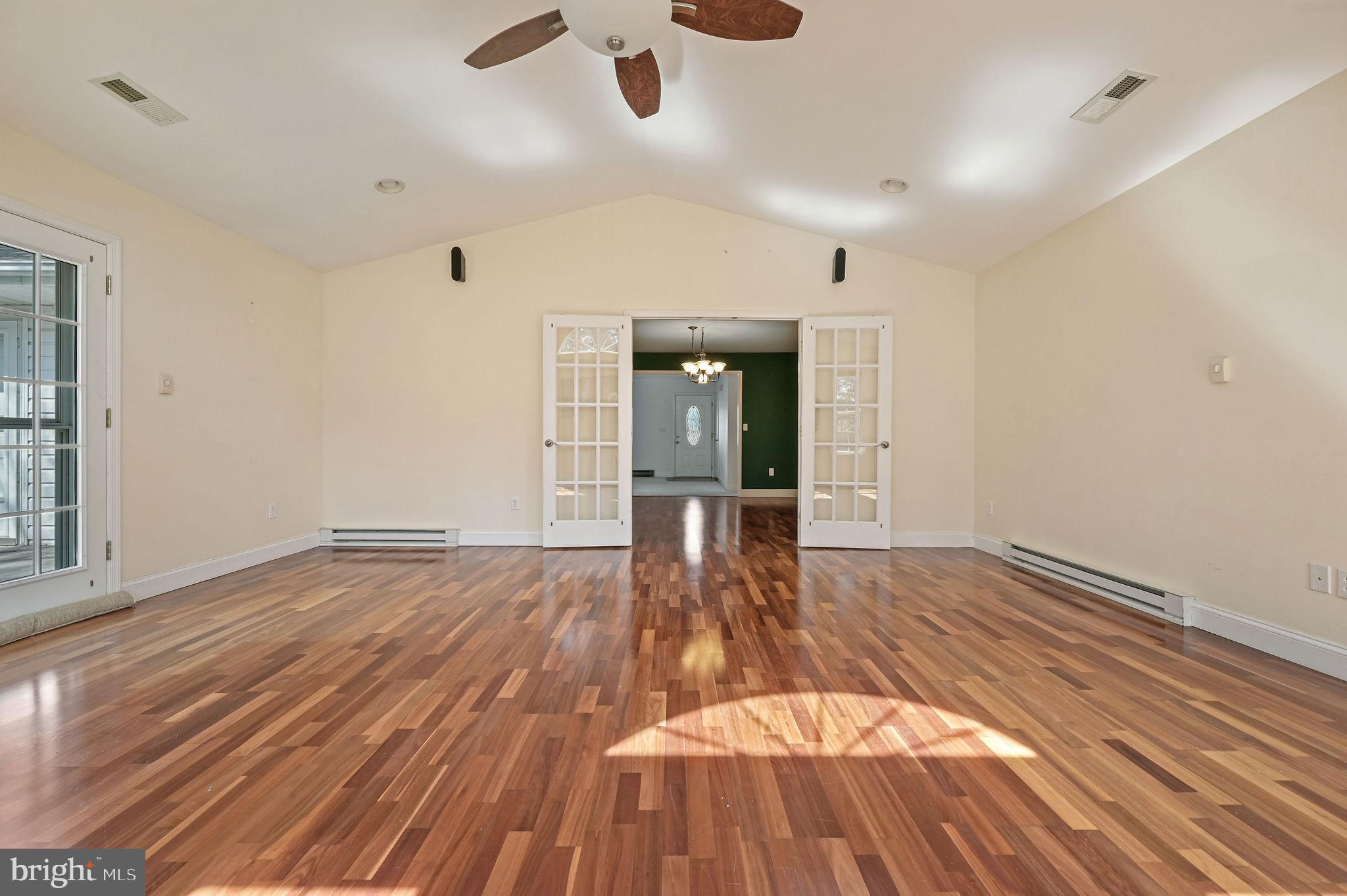 231 East Evens Road Viola, DE 19979 - Photo 7 of 36 a view of empty room with wooden floor and fan