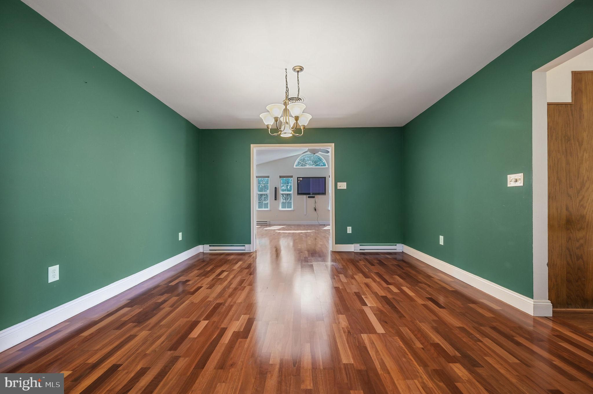 231 East Evens Road Viola, DE 19979 - Photo 9 of 36 a view of a room with wooden floor staircase and a kitchen