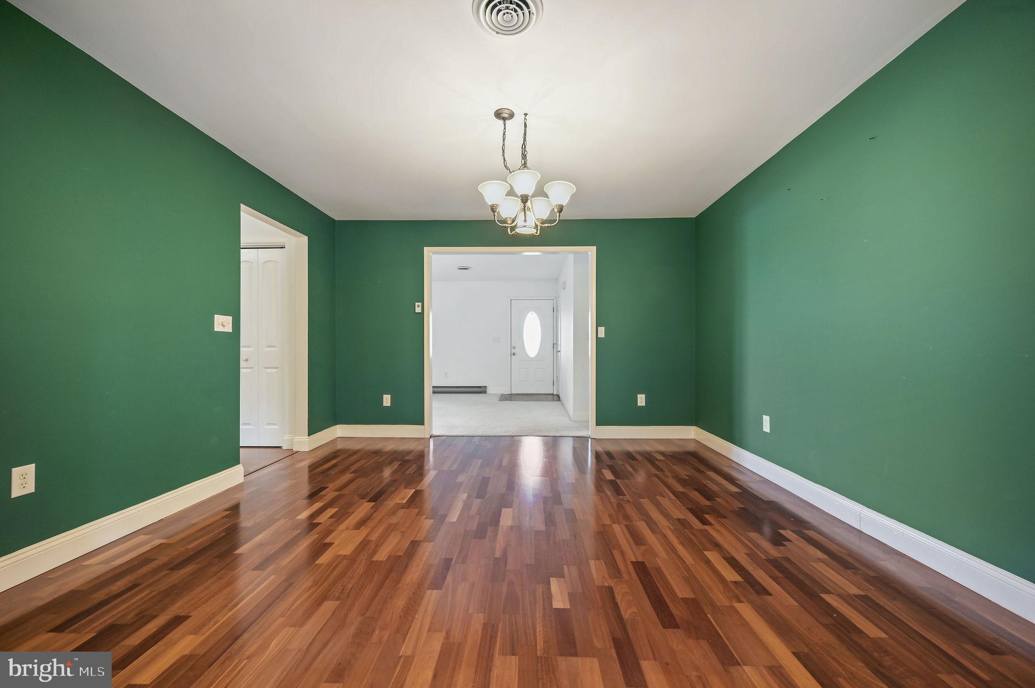 231 East Evens Road Viola, DE 19979 - Photo 10 of 36 a view of a room with wooden floor staircase and a kitchen