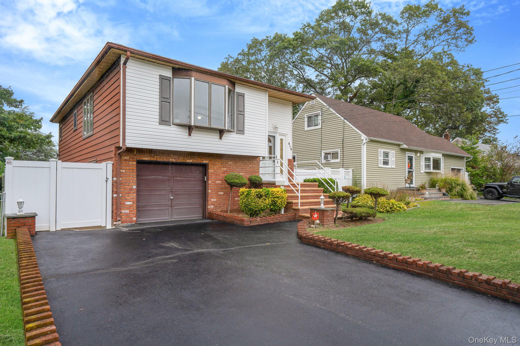 813 Windmill Avenue West Babylon, NY 11704 - Photo 1 of 32 a front view of a house with garden
