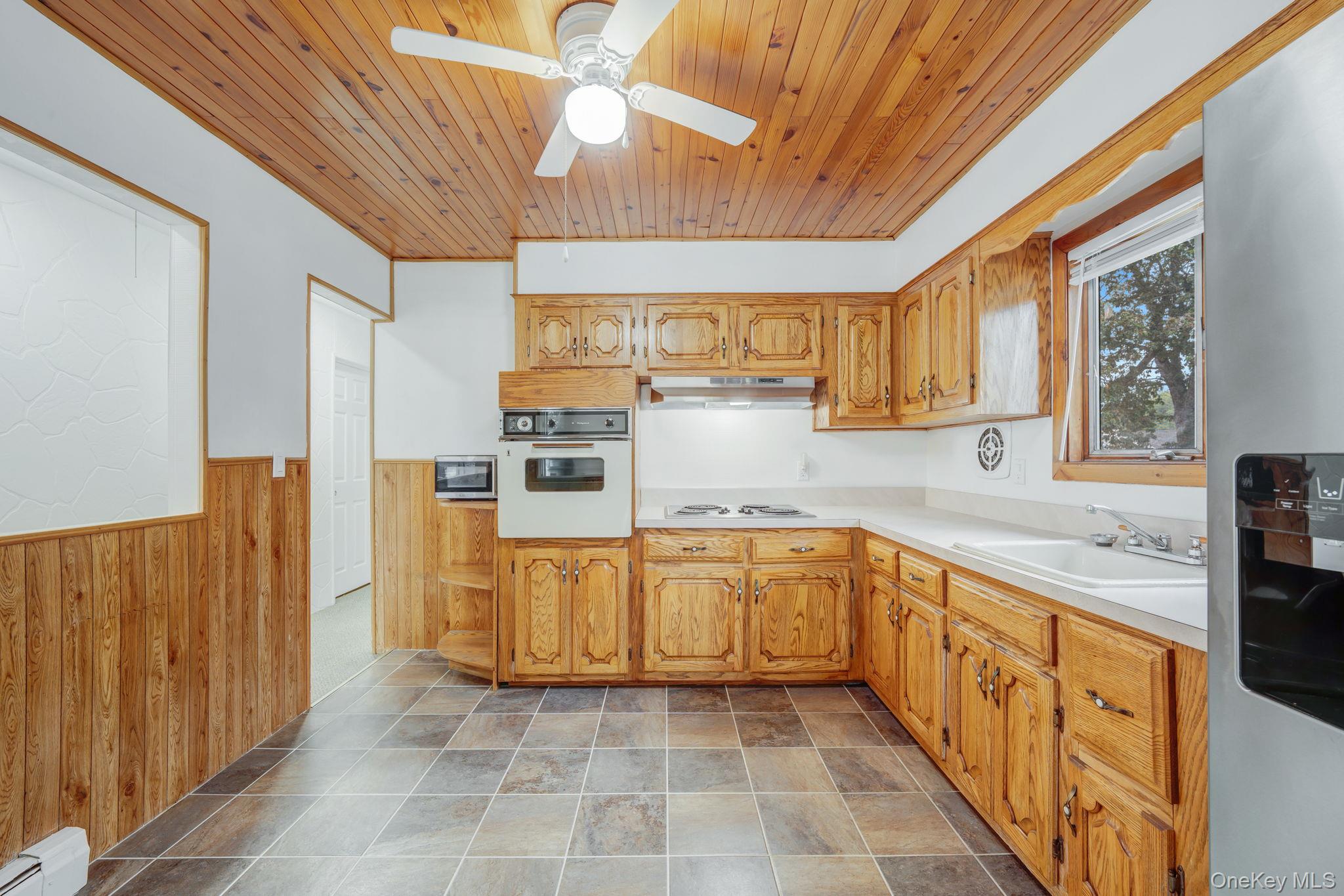 813 Windmill Avenue West Babylon, NY 11704 - Photo 19 of 32 a large kitchen with stainless steel appliances kitchen island granite countertop a refrigerator and a sink