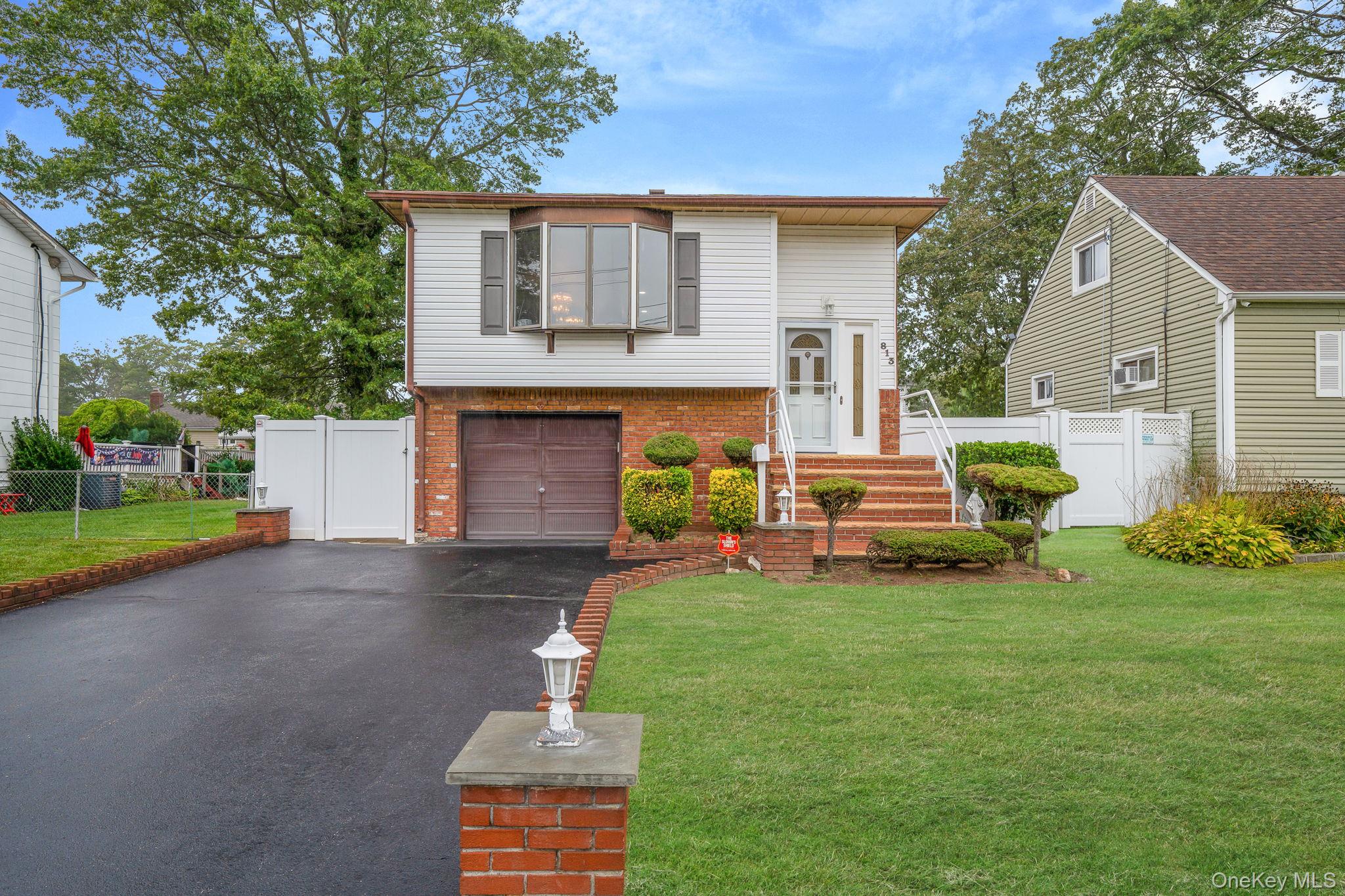813 Windmill Avenue West Babylon, NY 11704 - Photo 2 of 32 a front view of house with yard and green space
