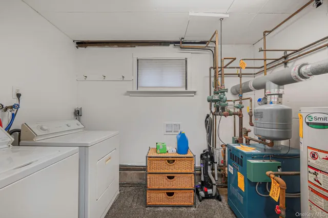 a utility room with cabinets dryer and washer