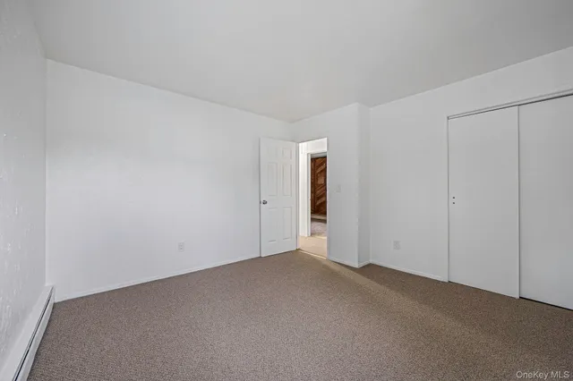 a view of an empty room and entryway