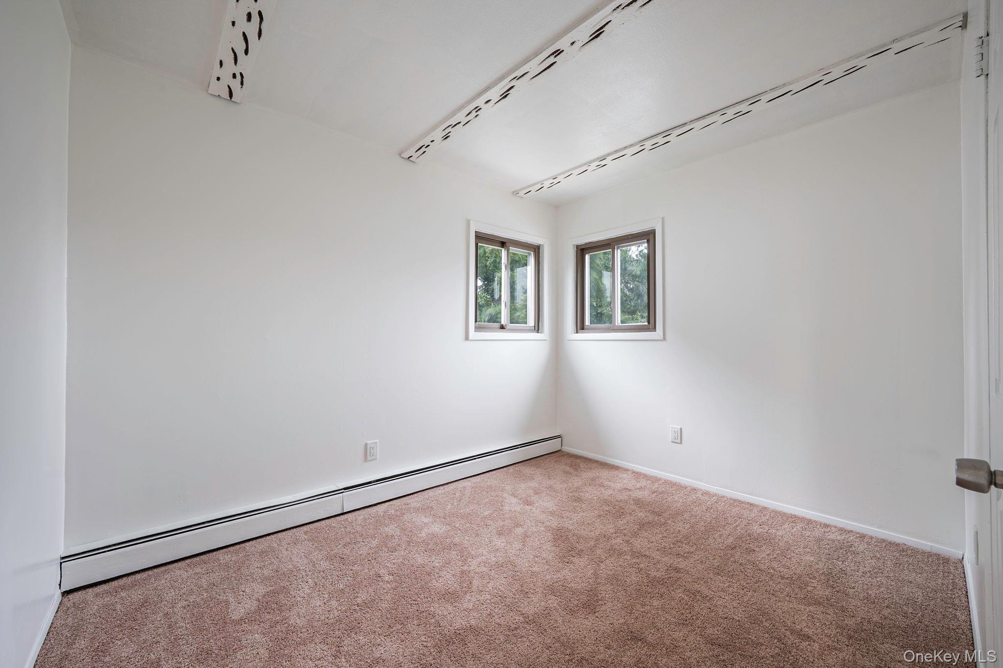 813 Windmill Avenue West Babylon, NY 11704 - Photo 6 of 32 an empty room with windows