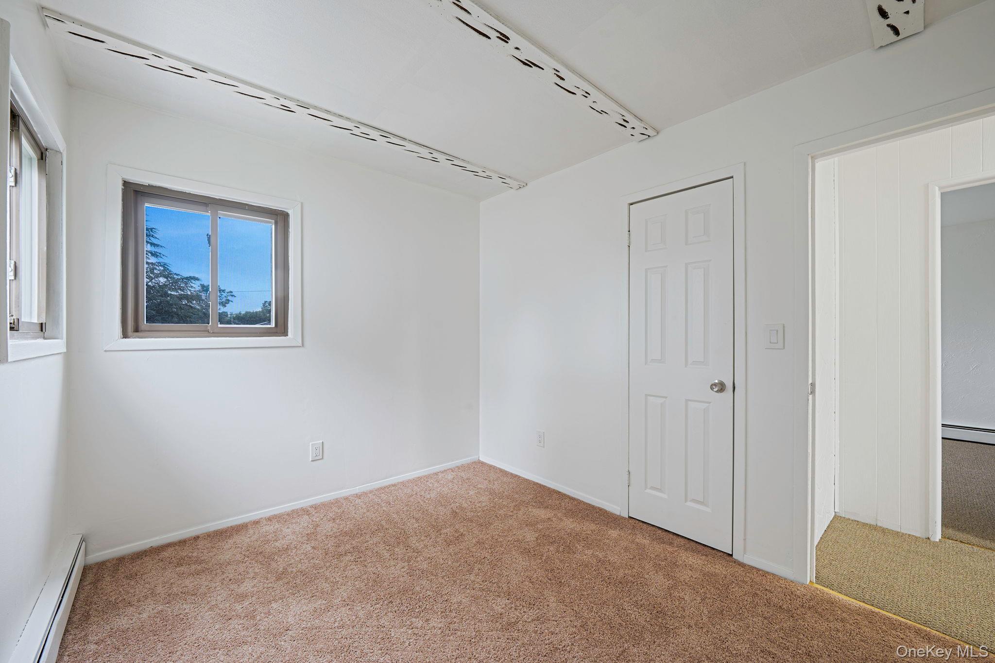 813 Windmill Avenue West Babylon, NY 11704 - Photo 7 of 32 a view of an empty room with a window
