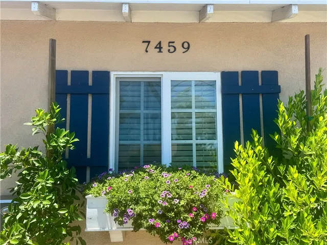 a sign that is in front of flowers