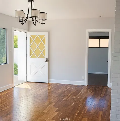 a view of room with wooden floor and window