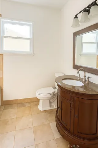 a bathroom with a sink toilet and mirror