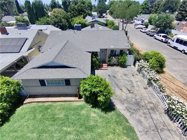 an aerial view of a house with a yard