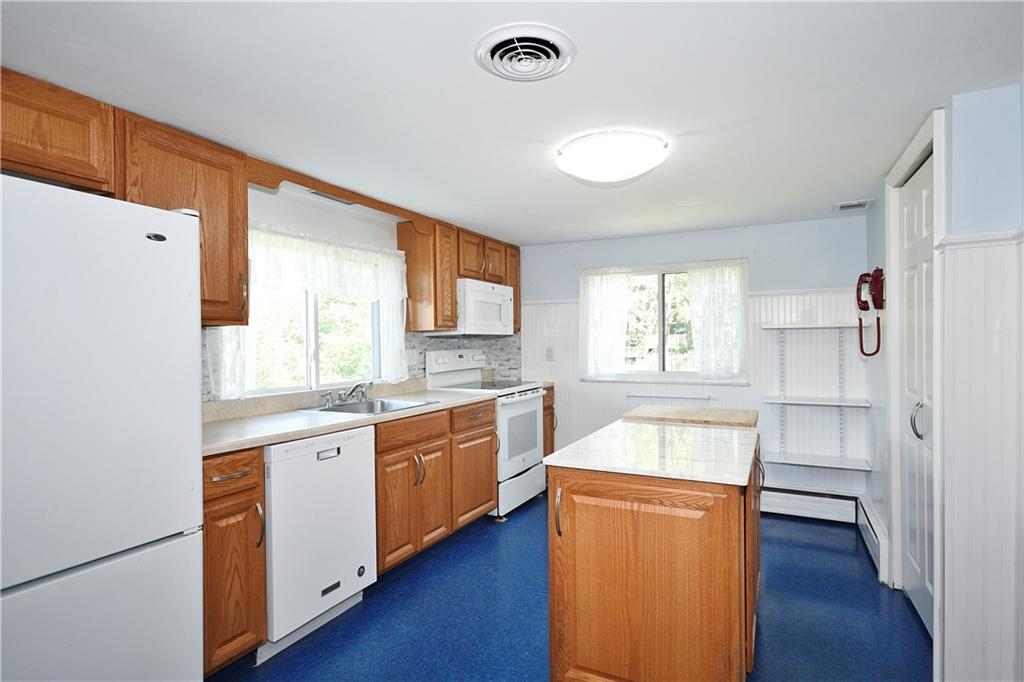 1360 Washington Road Pittsburgh, PA 15228 - Photo 11 of 44 a kitchen with stainless steel appliances granite countertop a refrigerator a sink dishwasher and white cabinets with wooden floor