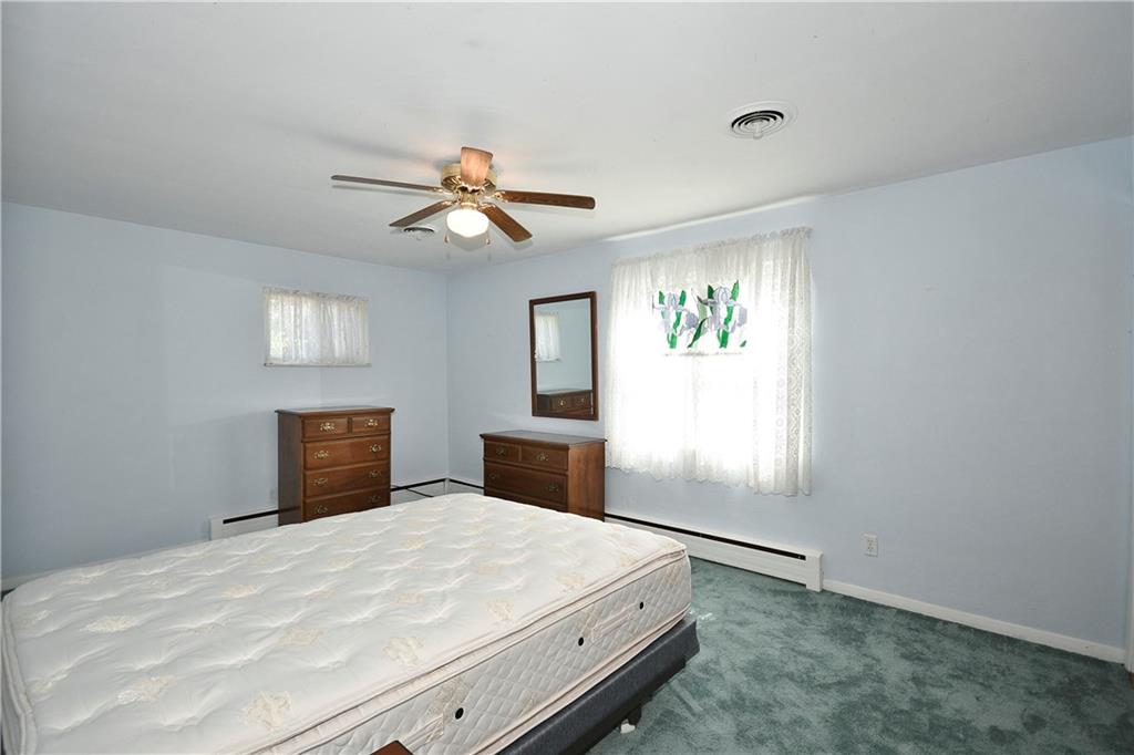 1360 Washington Road Pittsburgh, PA 15228 - Photo 17 of 44 a bedroom with a large bed and a chandelier