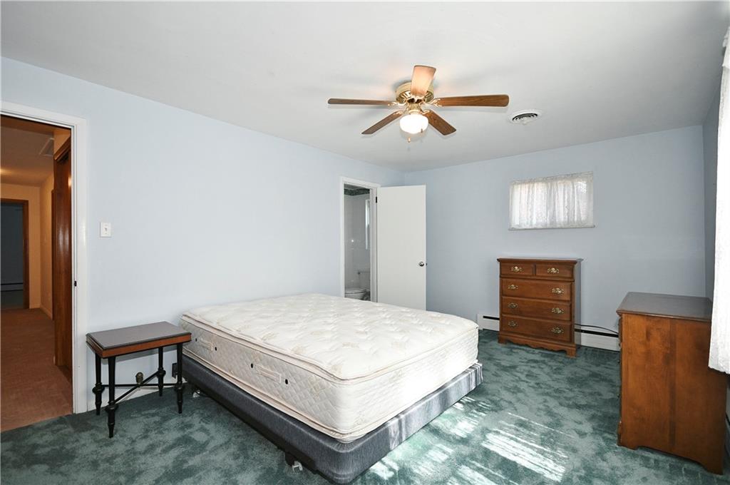 1360 Washington Road Pittsburgh, PA 15228 - Photo 19 of 44 a spacious bedroom with a bed and a chandelier