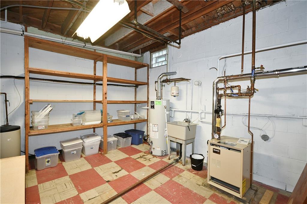 1360 Washington Road Pittsburgh, PA 15228 - Photo 39 of 44 a storage room with water heater and wooden floor