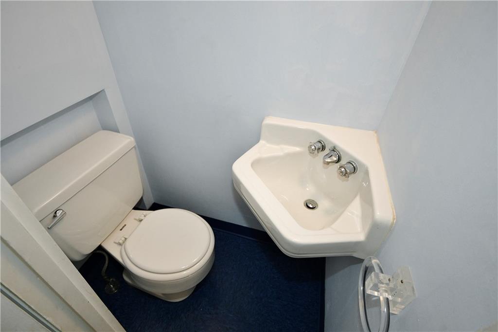 1360 Washington Road Pittsburgh, PA 15228 - Photo 40 of 44 a white toilet sitting next to a bathroom sink