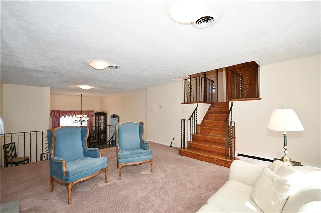 1360 Washington Road Pittsburgh, PA 15228 - Photo 6 of 44 a living room with furniture and a chair