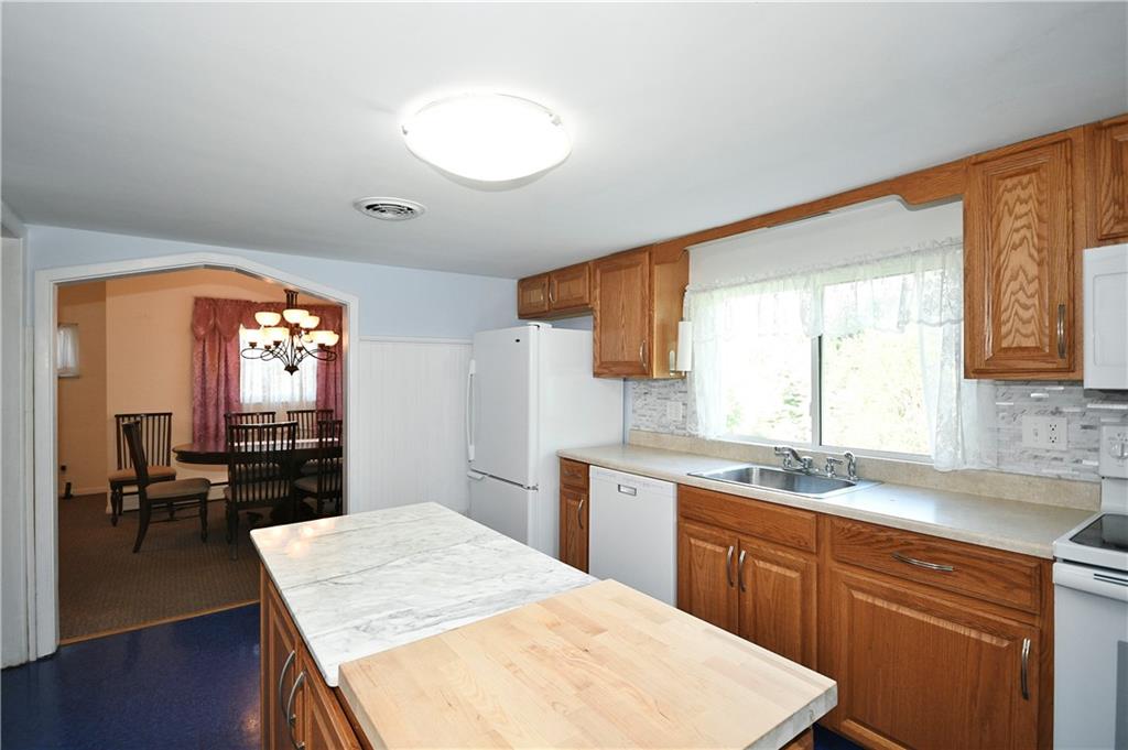 1360 Washington Road Pittsburgh, PA 15228 - Photo 10 of 44 a kitchen with a stove a sink a dining table and chairs