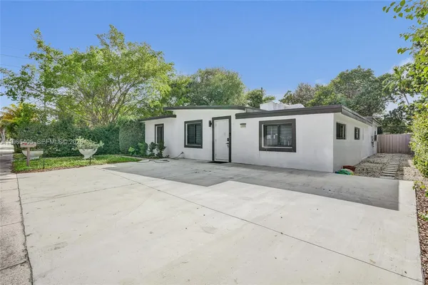 a view of house with outdoor space and tree