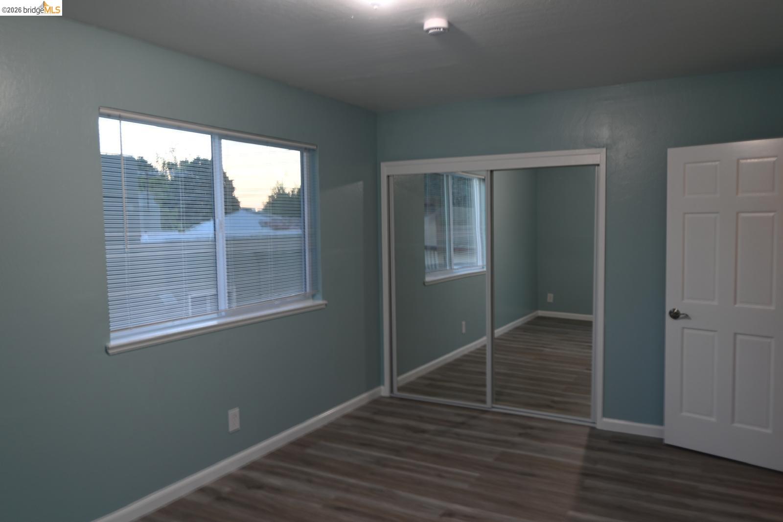 1316 Russell Street Berkeley, CA 94702 - Photo 12 of 23 an empty room with wooden floor and a window