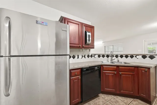 a kitchen with stainless steel appliances granite countertop a sink and cabinets