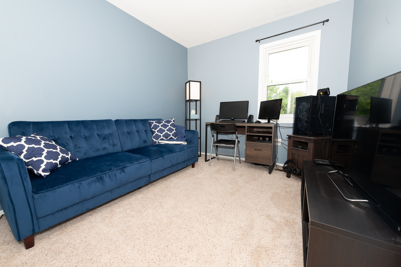 322 Rodenburg Road Roselle, IL 60172 - Photo 5 of 17 a living room with furniture a flat screen tv and a refrigerator