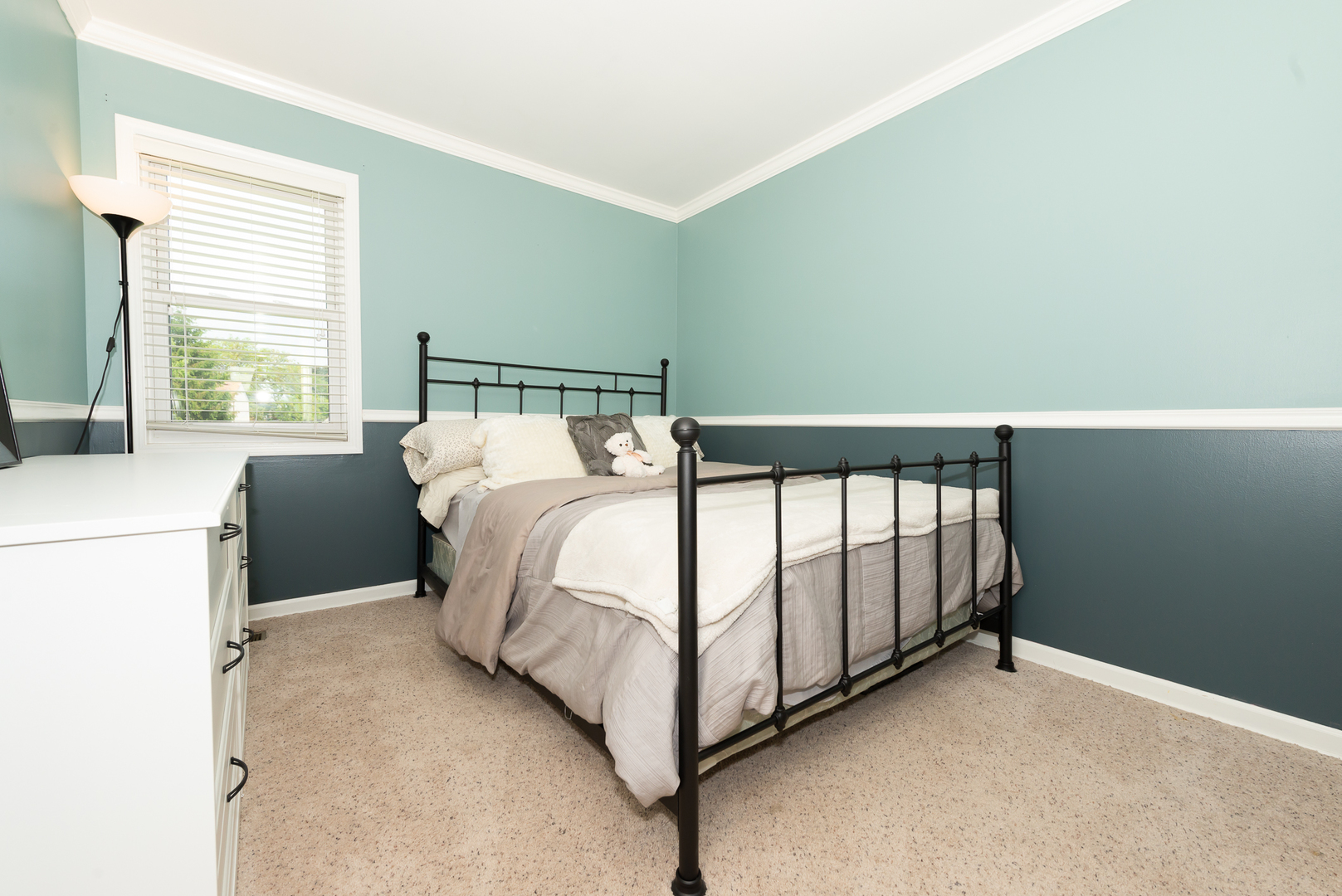 322 Rodenburg Road Roselle, IL 60172 - Photo 6 of 17 a bed sitting in a bedroom next to a window