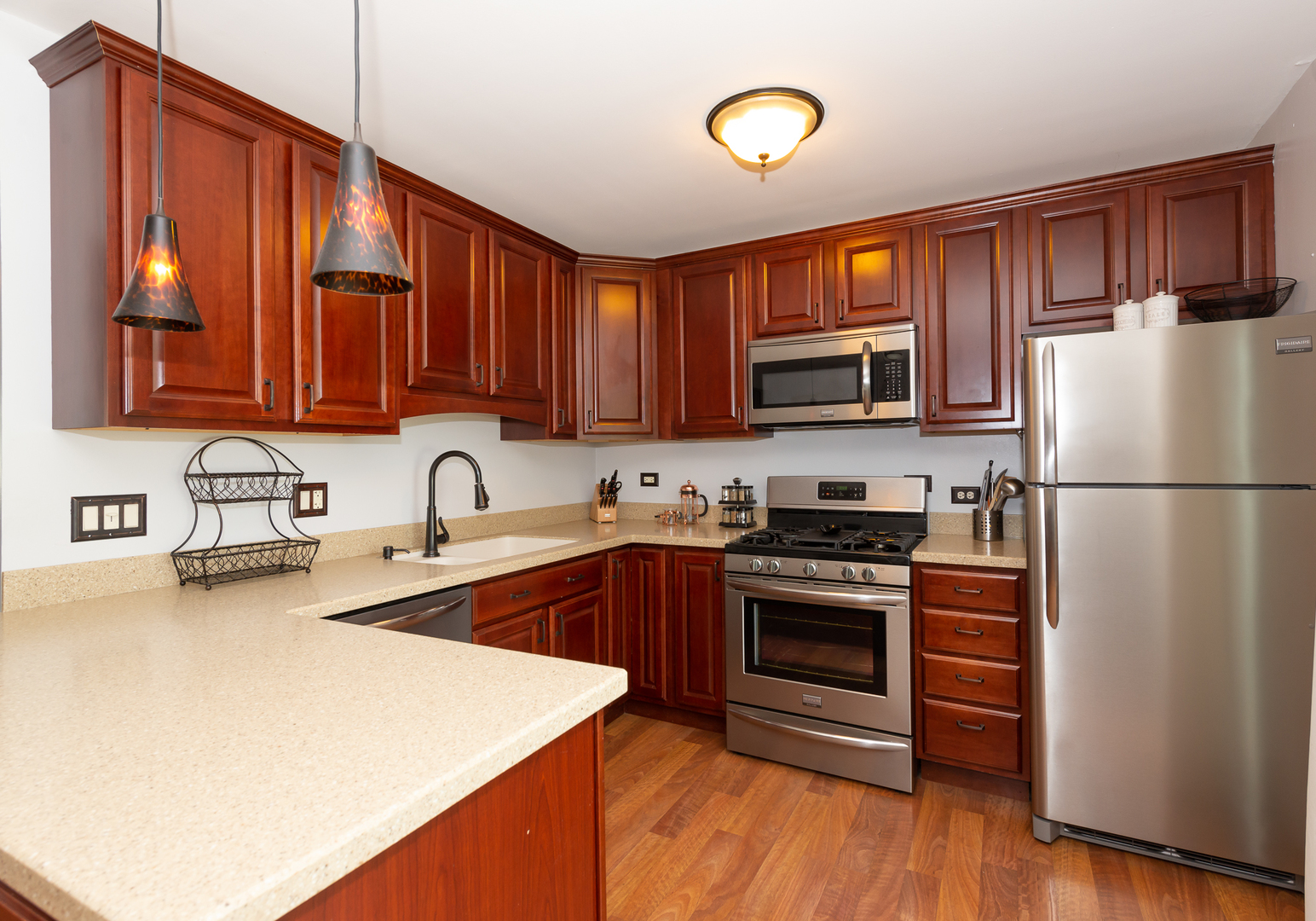 322 Rodenburg Road Roselle, IL 60172 - Photo 8 of 17 a kitchen with stainless steel appliances granite countertop a stove top oven a sink and a refrigerator with wooden floor