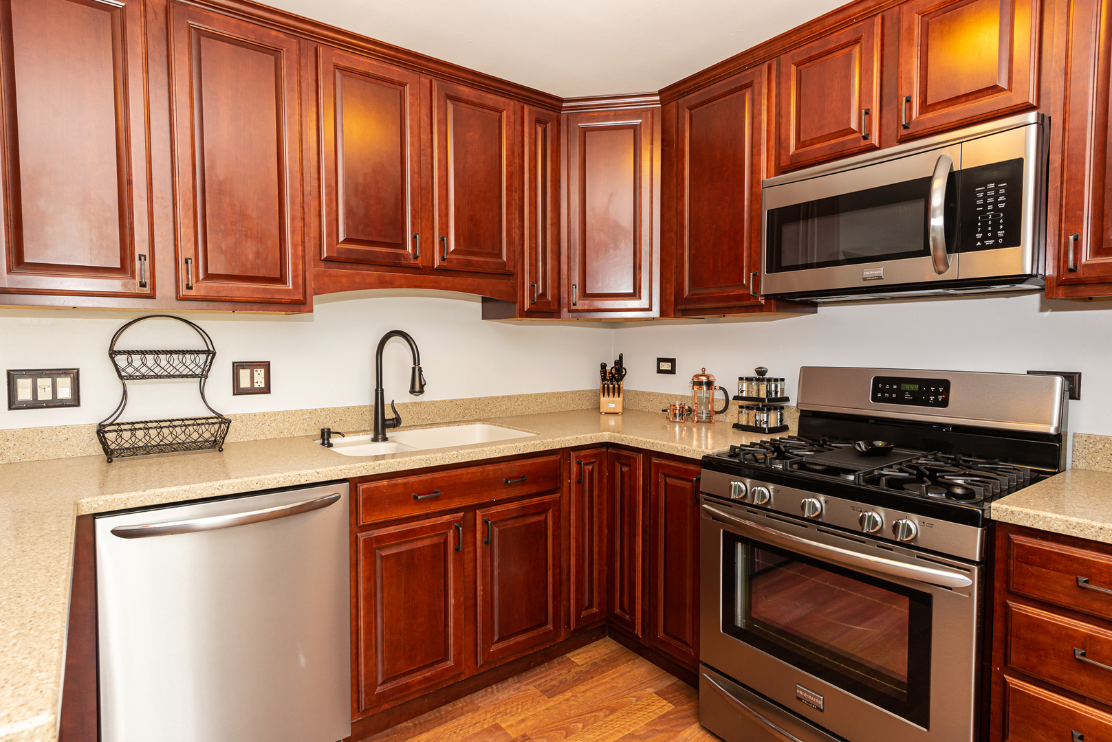 322 Rodenburg Road Roselle, IL 60172 - Photo 9 of 17 a kitchen with stainless steel appliances granite countertop a sink stove and microwave
