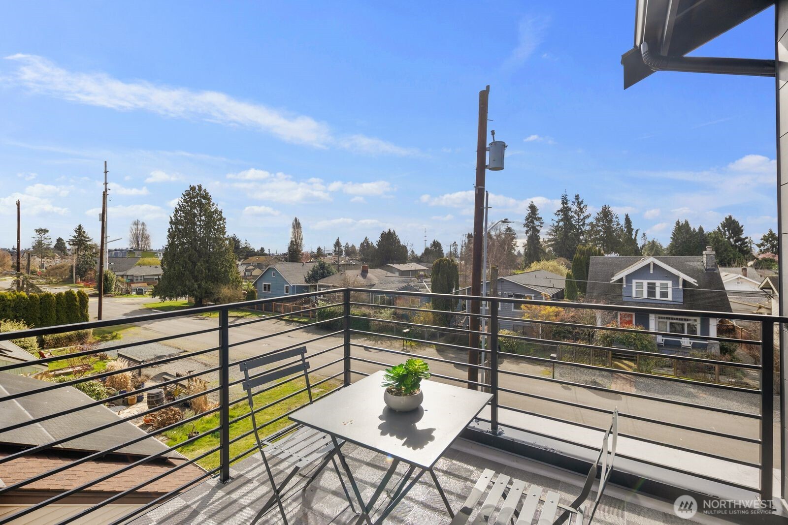 520 North 102nd Street Seattle, WA 98133 - Photo 15 of 20 a view of a city from a balcony with a potted plant