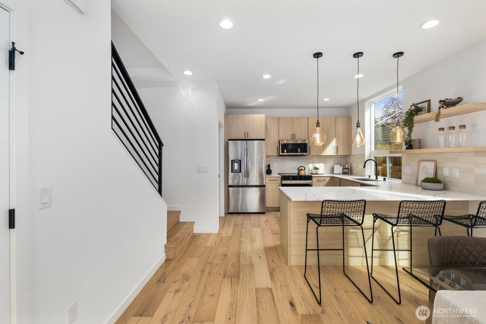520 North 102nd Street Seattle, WA 98133 - Photo 7 of 20 a kitchen with stainless steel appliances granite countertop a sink a stove a refrigerator and island with wooden floor