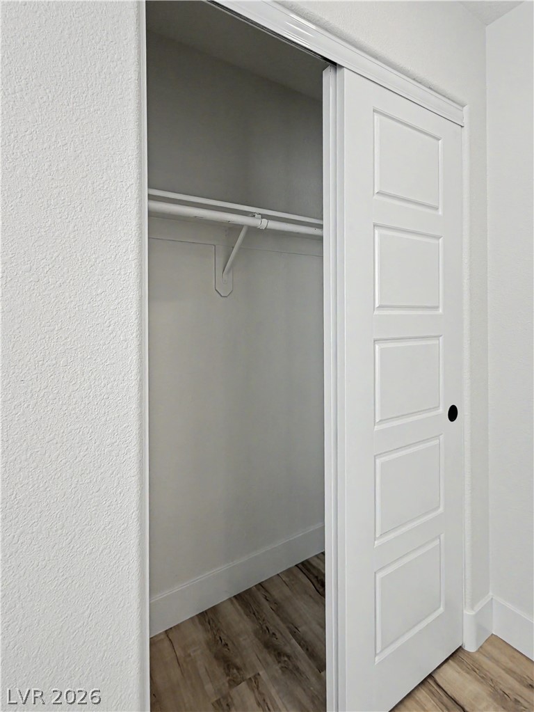 8977 Paige Rene Court Las Vegas, NV 89117 - Photo 30 of 31 Sliding panel doors reveal a closet with robust shelving and a clothes rod for convenient storage.