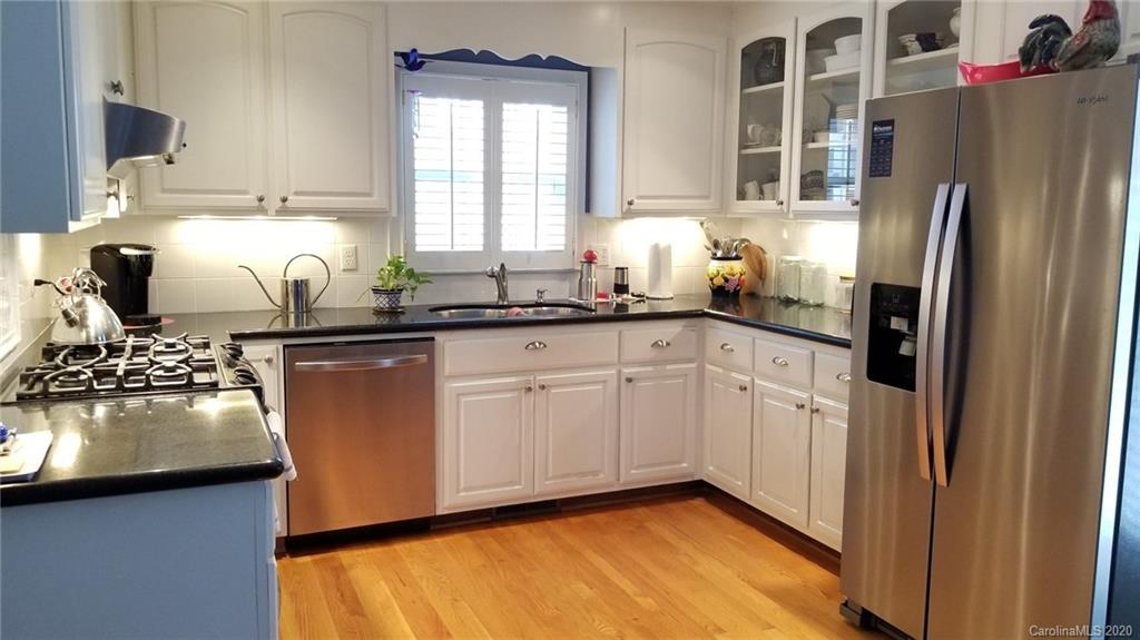 225 Pine Street Fort Mill, SC 29715 - Photo 12 of 40 a kitchen with stainless steel appliances granite countertop a refrigerator sink and cabinets
