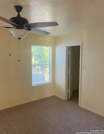 a view of an empty room and a window