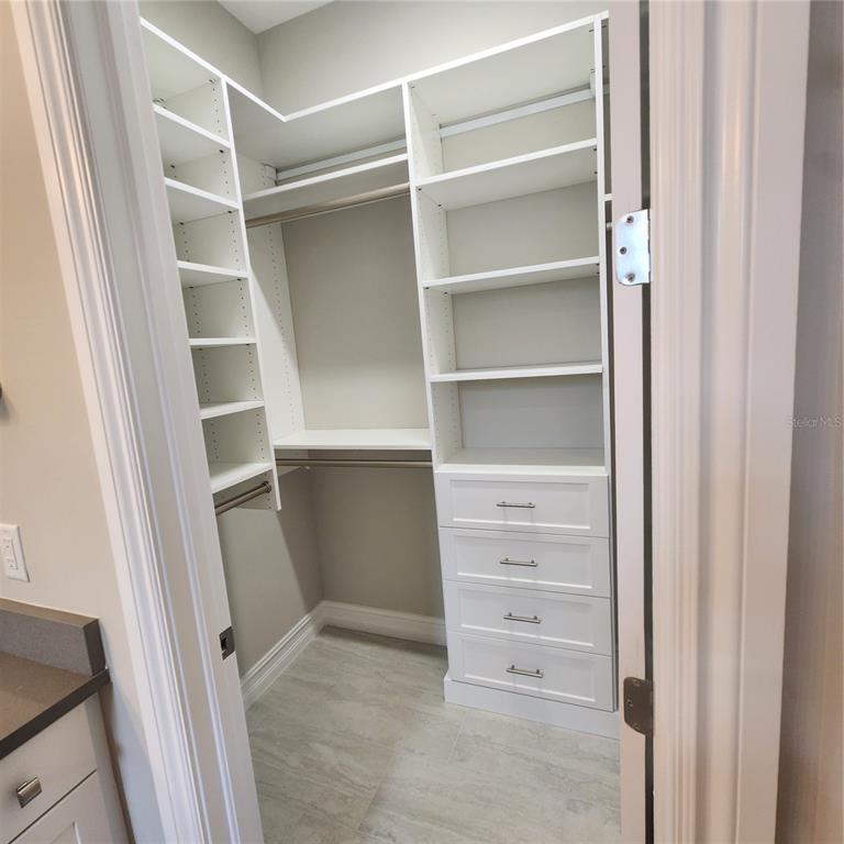 512 Blue Shell Loop Sarasota, FL 34240 - Photo 33 of 44 a view of walk in closet with empty racks