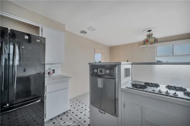 a kitchen with stainless steel appliances granite countertop a refrigerator and a stove