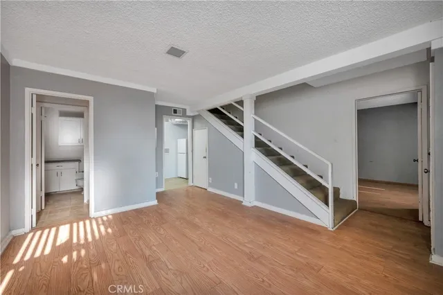 a bathroom with a granite countertop toilet and a sink
