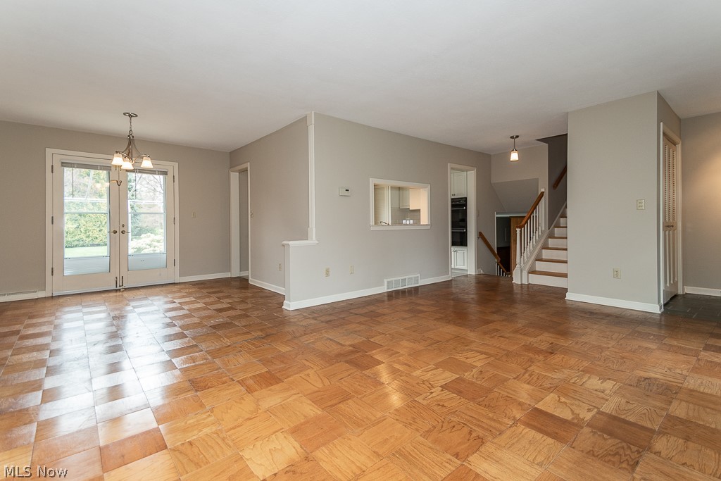 Original oak flooring, fresh neutral paint and new light fixture in this inviting living area