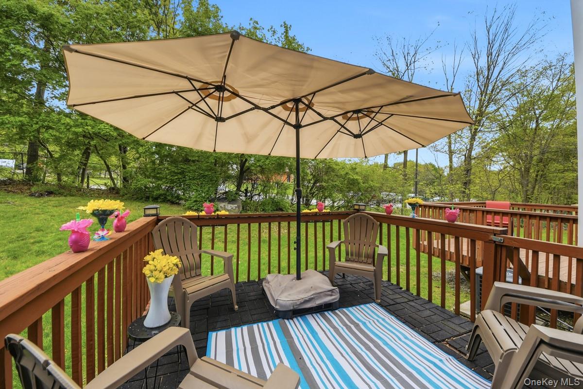 708 Mallard Way Peekskill, NY 10566 - Photo 12 of 29 a view of a balcony with wooden floor and outdoor seating