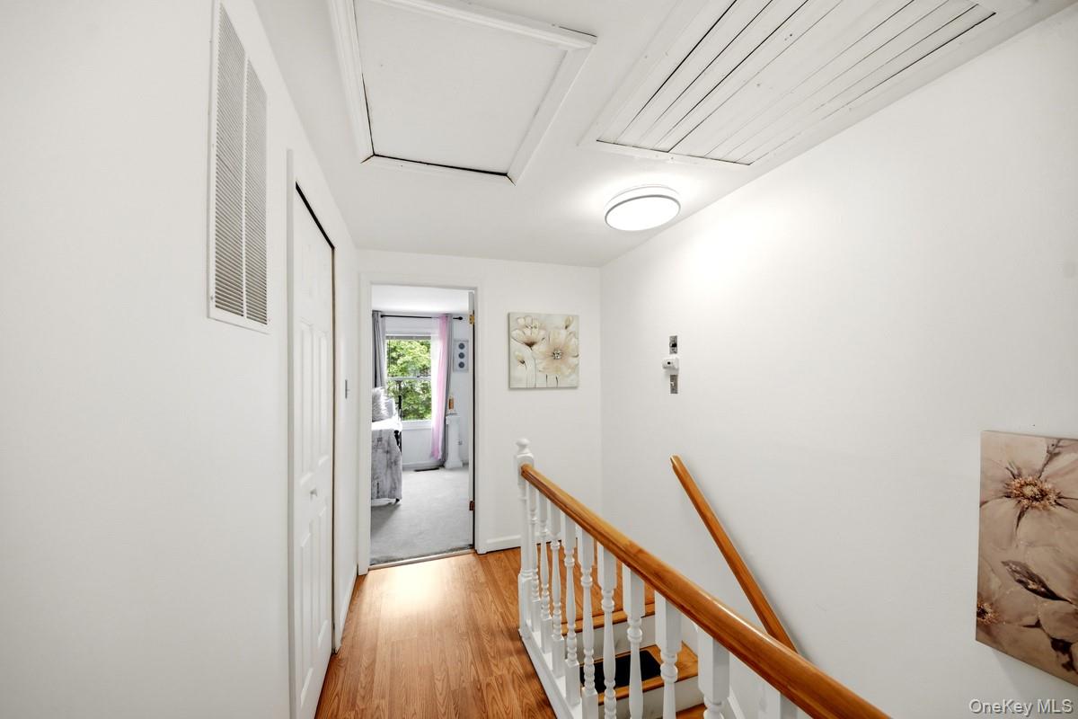 708 Mallard Way Peekskill, NY 10566 - Photo 14 of 29 a view of a hallway with wooden floor and staircase