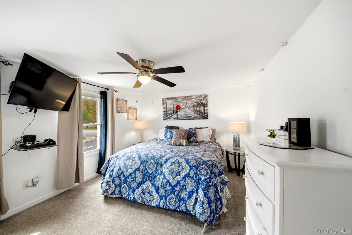 708 Mallard Way Peekskill, NY 10566 - Photo 16 of 29 a bedroom with a bed and a flat screen tv
