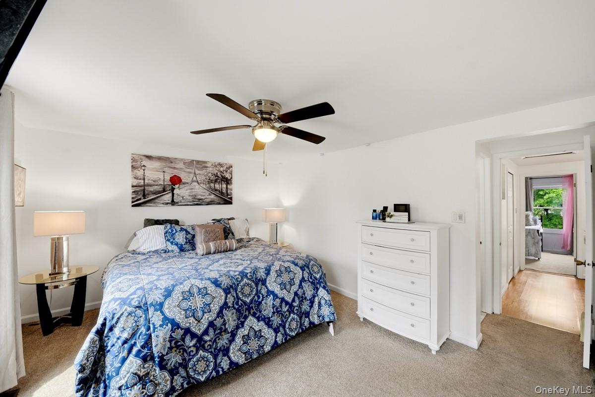 708 Mallard Way Peekskill, NY 10566 - Photo 17 of 29 a bedroom with a large bed and a chandelier