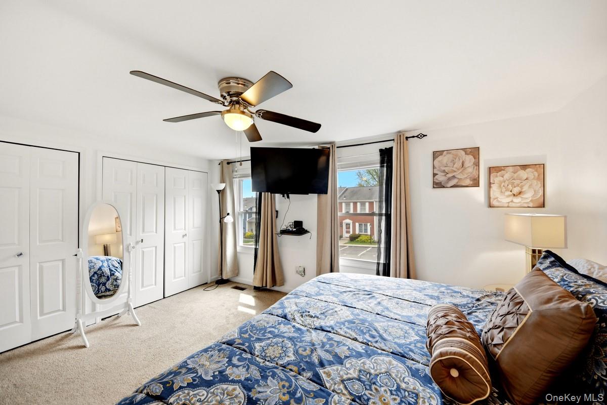 708 Mallard Way Peekskill, NY 10566 - Photo 18 of 29 a bedroom with a bed and a chandelier