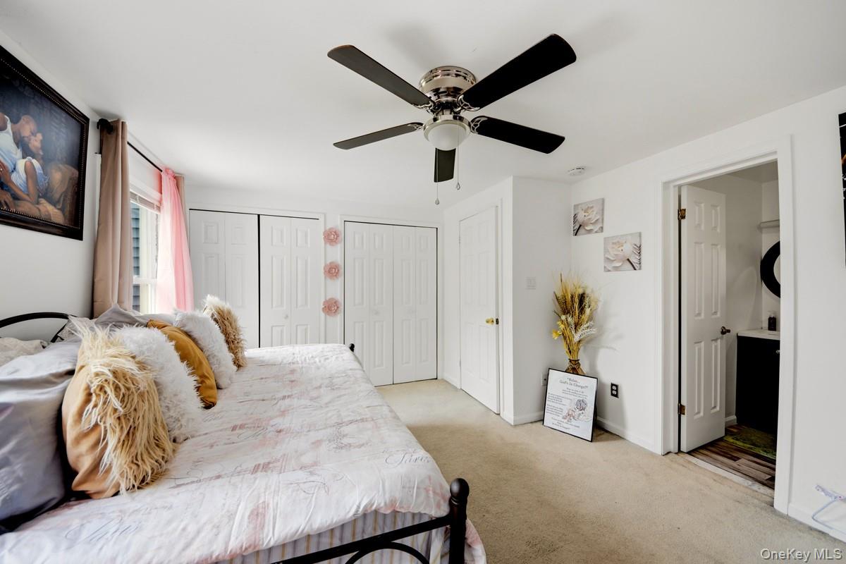 708 Mallard Way Peekskill, NY 10566 - Photo 20 of 29 a bedroom with a bed and a ceiling fan